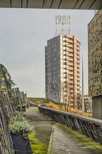 Bridge over canal amidst buildings against sky