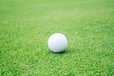 Close-up of golf ball on field