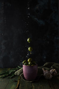 Levitating olives with oil drops and salt