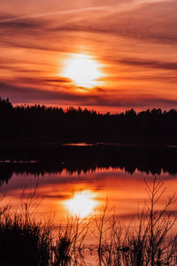 Scenic view of lake against romantic sky at sunset