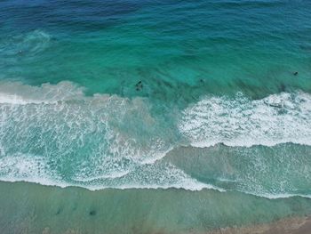 High angle view of waves rushing towards shore