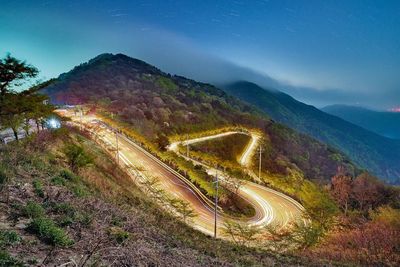 High angle view of road amidst mountains against sky at night