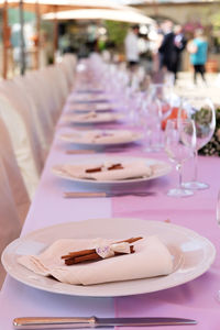 Table set for the wedding reception. plate cutlery and napkins, with flowers in the centerpiece