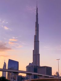 Modern cityscape against sky during sunset