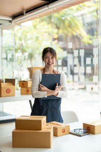 Portrait of smiling entrepreneur working at shop