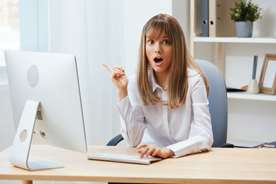 Portrait of young businesswoman working on table