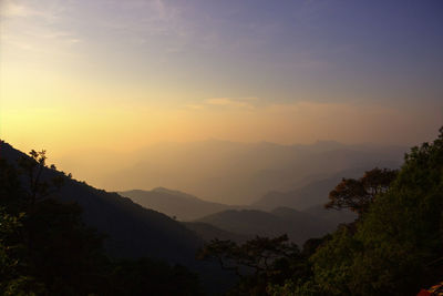 Scenic view of silhouette mountains against sky at sunset