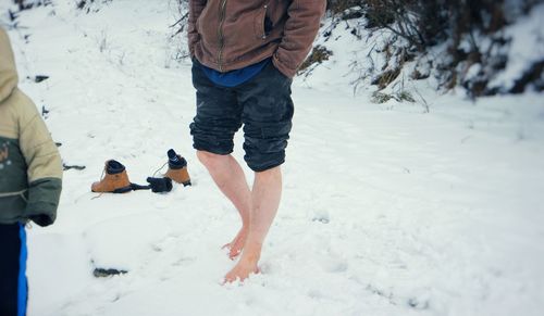 Low section of men on snow