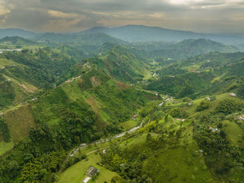 High angle view of mountains and trees against sky