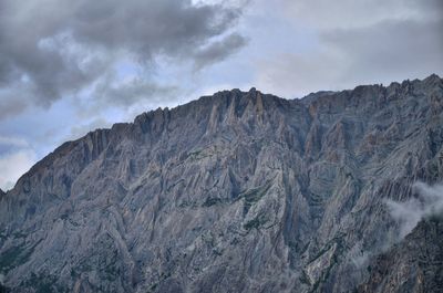 Scenic view of mountains against cloudy sky