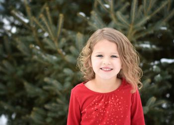 Portrait of smiling girl against plants