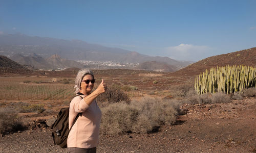 Full length of man on arid landscape against sky