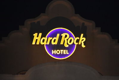 Low angle view of illuminated sign at night