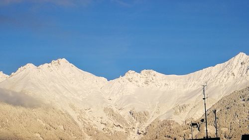 Scenic view of mountains against clear blue sky