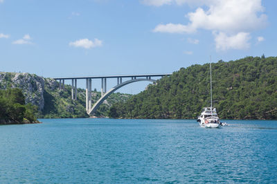 A boat approaches a bridge in the croatian coastal waters.