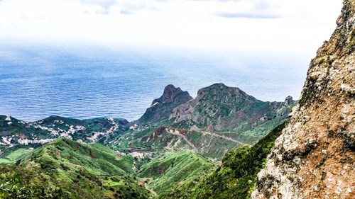 High angle view of rocks by sea against sky