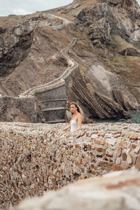 Woman sitting on rock