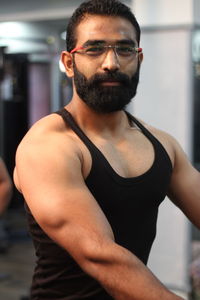 Portrait of smiling bearded man at gym