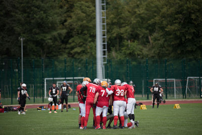 Group of people playing soccer on field