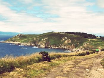 Scenic view of sea and mountains against sky