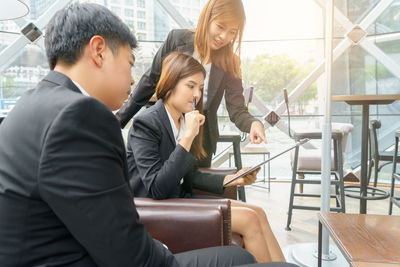 Group of people using mobile phone at table