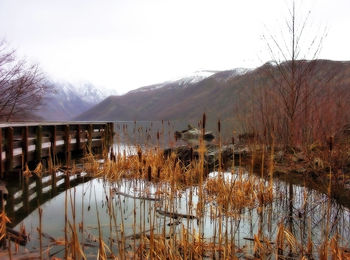 Scenic view of lake and mountains against sky