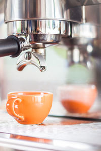 Close-up of pouring coffee in cafe