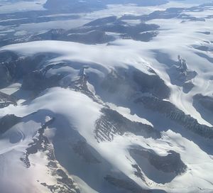 Aerial view of snowcapped landscape against sky