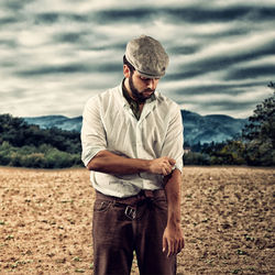 Full length of young man looking away