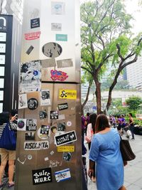 Rear view of people walking in city