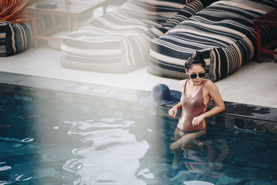 Full length of young woman in swimming pool