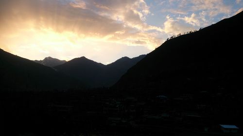 Scenic view of mountains against sky at sunset