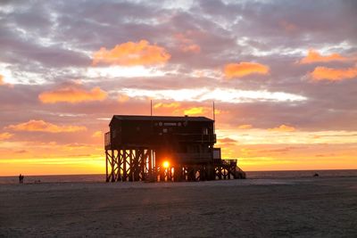 Scenic view of beach against sky during sunset