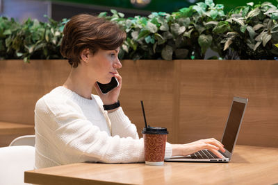 Young woman using laptop on table