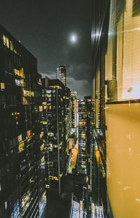 Illuminated cityscape against sky at night