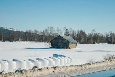 House in winter against clear sky