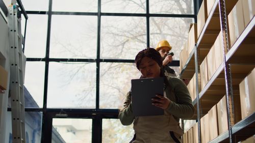 Side view of young woman standing in office