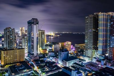 Aerial view of illuminated buildings in city at night