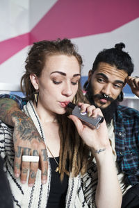 Young couple using an electronic cigarette