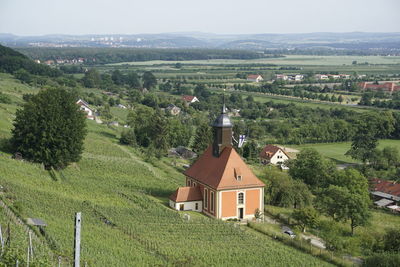 High angle view of trees and houses on field