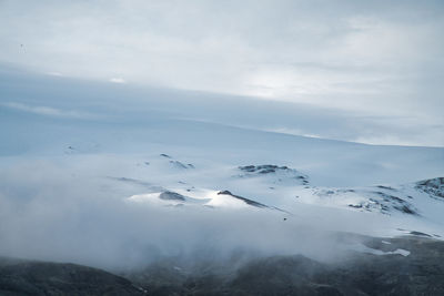 Aerial view of snowcapped mountains against sky