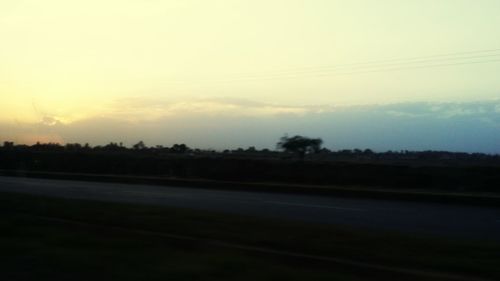 Scenic view of landscape against sky at sunset