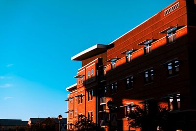 Low angle view of buildings against clear blue sky