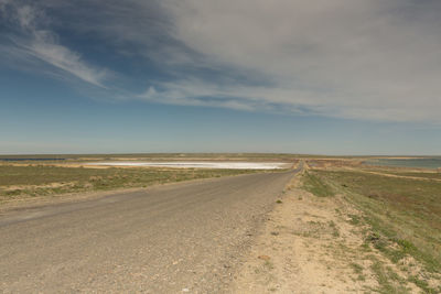 Dirt road along countryside landscape