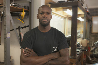 Portrait of young man standing at home