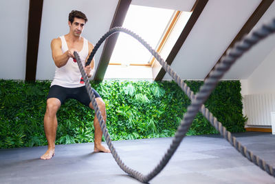 Portrait of young woman exercising in gym