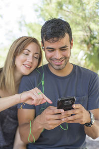 People listening music while using mobile phone