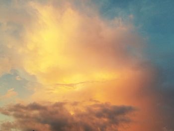 Low angle view of cloudy sky at sunset