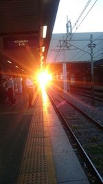 View of railroad station platform at sunset