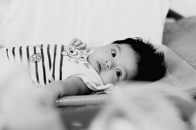 Portrait of boy lying on bed